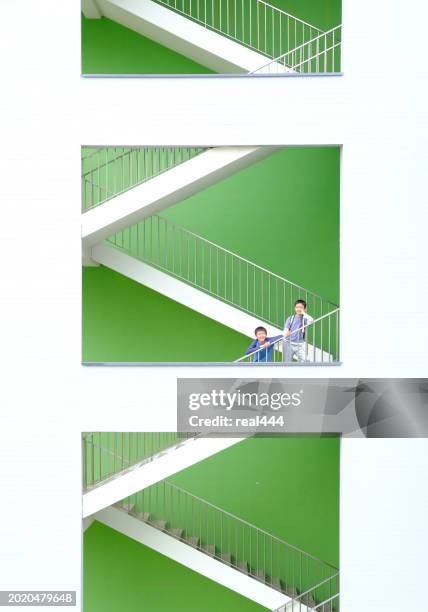 two boys climbing up  the stairs. - school railings stock pictures, royalty-free photos & images