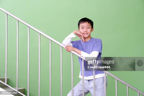 the boy walks upstairs - school railings stock pictures, royalty-free photos & images