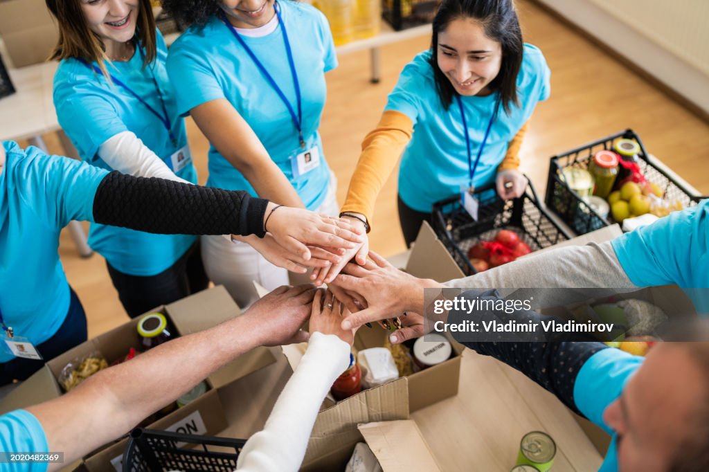 Volunteers hands stacking in a circle