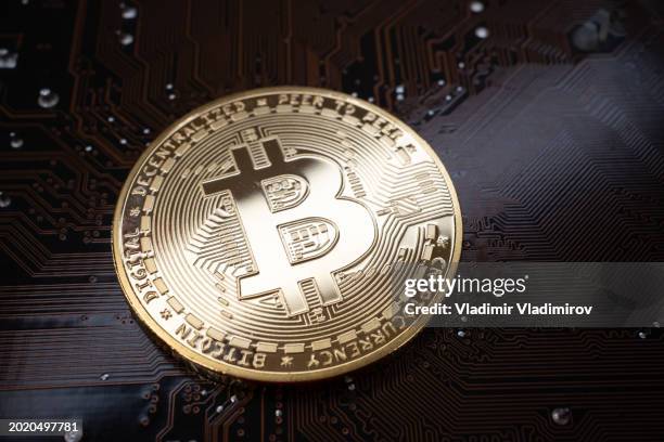 symbolic bitcoin on us dollar banknotes - printed circuit b stock pictures, royalty-free photos & images