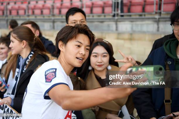 Shuang Wang of Tottenham Hotspur poses for a photograph with fans, as she takes a selfie on a mobile phone, after the Barclays Women's Super League...