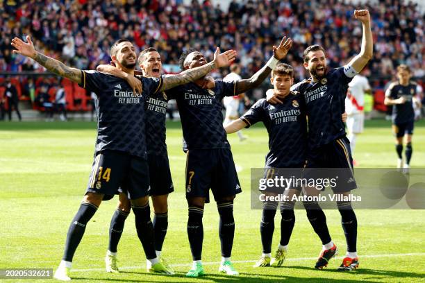 Joselu Mato player of Real Madrid celebrates with his teammates after scoring a goal during the LaLiga EA Sports match between Rayo Vallecano and...