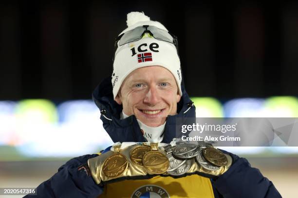 Johannes Thingnes Boe of Norway poses for a photograph with his medals as he celebrates after finishing in First Place after competing in Men's 15KM...