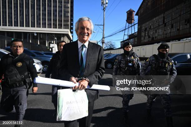 Guatemalan journalist José Rubén Zamora, founder of the defunct newspaper El Periódico, arrives handcuffed and escorted by police for a hearing at...