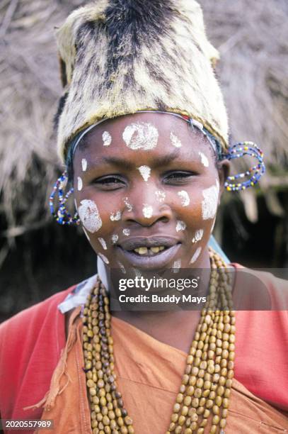 Portrait of a Kikuyu woman in paint and traditional dress at her village on the slopes of Mount Kenya, in Kenya, Africa, 2000. .