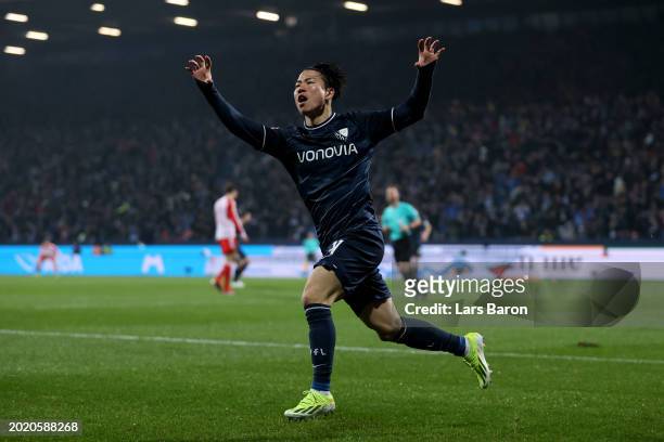 Takuma Asano of VfL Bochum celebrates scoring his team's first goal during the Bundesliga match between VfL Bochum 1848 and FC Bayern München at...