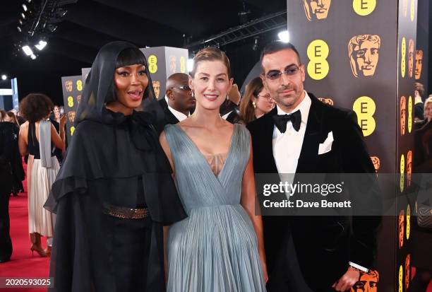 Naomi Campbell, Rosamund Pike and Mohammed Al Turki attend the 2024 EE BAFTA Film Awards at The Royal Festival Hall on February 18, 2024 in London,...