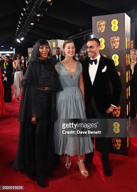 Naomi Campbell, Rosamund Pike and Mohammed Al Turki attend the 2024 EE BAFTA Film Awards at The Royal Festival Hall on February 18, 2024 in London,...