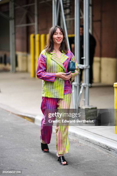 Guest wears a neon yellow / green and pirple striped full look, oversized blazer jacket, and wide-leg suit pants, black leather shoes, red lipstick,...