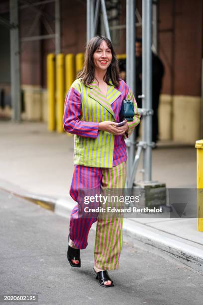 Guest wears a neon yellow / green and pirple striped full look, oversized blazer jacket, and wide-leg suit pants, black leather shoes, red lipstick,...