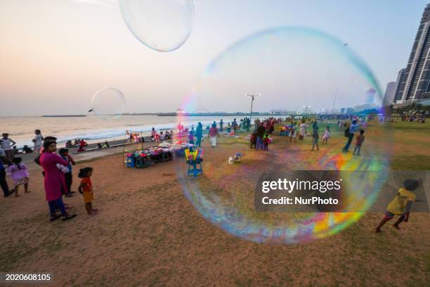 Children are playing with soap bubbles at the Galle Face promenade in Colombo, Sri Lanka, on February 21, 2024.
