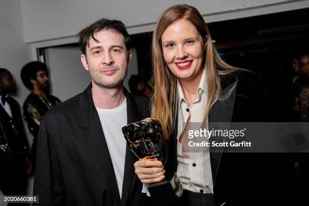 Arthur Harari and Justine Triet, win Original Screenplay Award for 'Anatomy of a Fall', backstage during the EE BAFTA Film Awards 2024 at The Royal...