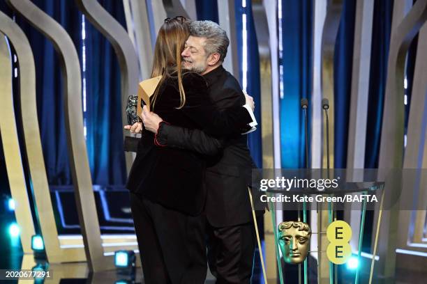 Andy Serkis and the Original Screenplay winner Justine Triet on stage during the EE BAFTA Film Awards 2024 at The Royal Festival Hall on February 18,...