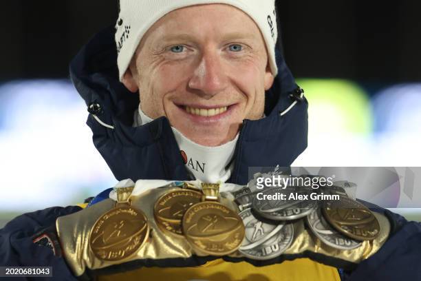 Johannes Thingnes Boe of Norway poses for a photograph with his medals as he celebrates after finishing in First Place after competing in Men's 15KM...