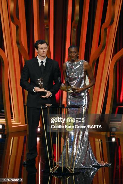 Callum Turner and Sheila Atim present the Cinematography Award on stage during the EE BAFTA Film Awards 2024 at The Royal Festival Hall on February...