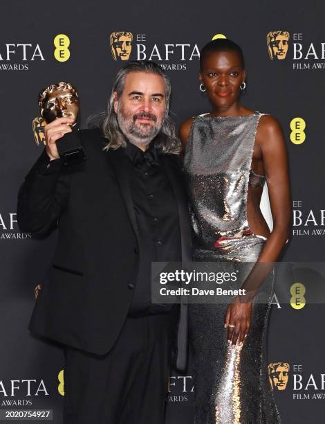 Hoyte van Hoytema and Sheila Atim pose with the Cinematography Award for 'Oppenheimer' in the winners room during the 2024 EE BAFTA Film Awards at...