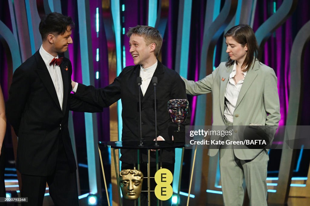 Bartosz Stanislawek, Ross Stringer and Aleksandra Sykulak accept the ...