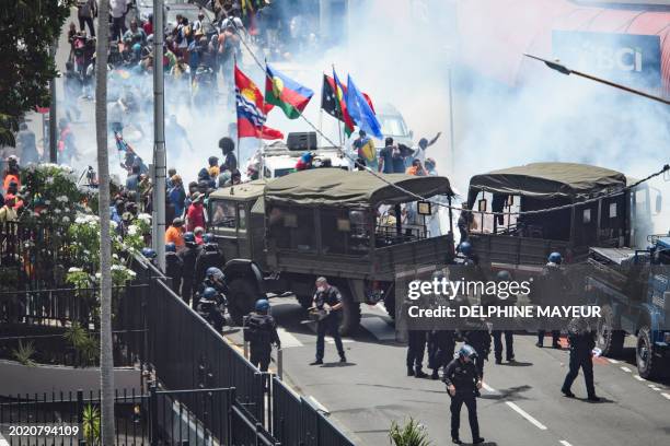 Protestors clash with French gendarmes and French Republican Security Corps police officers as they fired teargas during a demonstration called by...