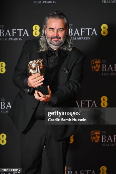 Hoyte van Hoytema poses with the Cinematography Award for 'Oppenheimer poses in the winners room at the 2024 EE BAFTA Film Awards at The Royal...