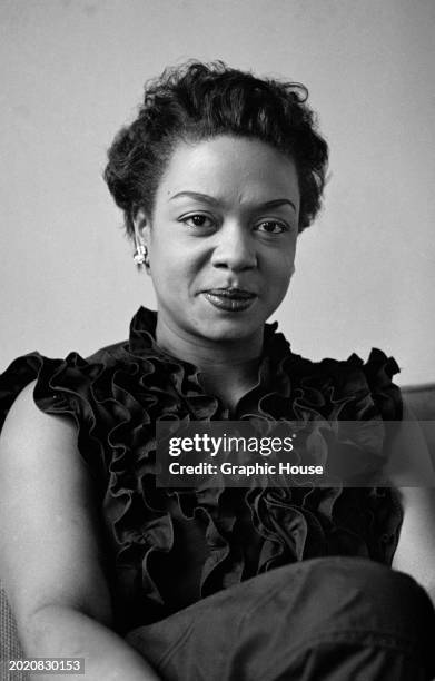 Trinidadian pianist and singer Hazel Scott, wearing a dark sleeveless ruffled top, at Frankfurt Airport , in Frankfurt am Main, Hesse, Gerrmany, 16th...