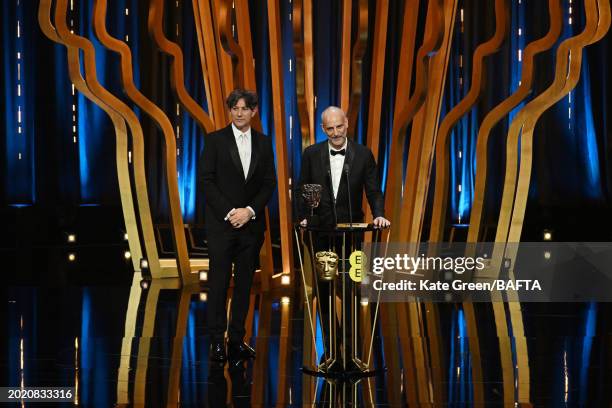 James Wilson and Jonathan Glazer accept the Film Not in the English Language Award for 'The Zone of Interest' during the 2024 EE BAFTA Film Awards,...