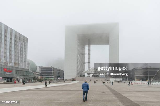 Commuters and office workers close to the Grande Arche monument in the La Defense business district of Paris, France, on Tuesday, Feb. 21, 2024....