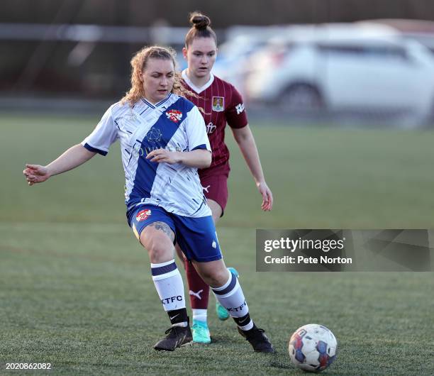 Emma Robinson of Kettering Town plays the ball watched by Paris Mallon of Northampton Town during the Northamptonshire FA Women's Cup Semi Final...