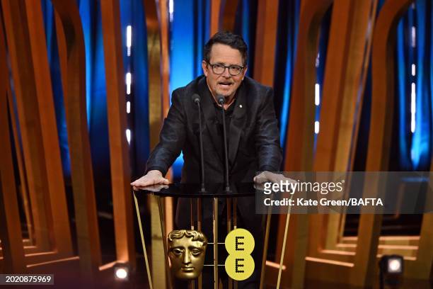 Michael J Fox presents the Best Film Award on stage during the EE BAFTA Film Awards 2024 at The Royal Festival Hall on February 18, 2024 in London,...