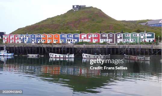 Colorful huts, shops, houses, boats around the harbor on Helgoland, Germany