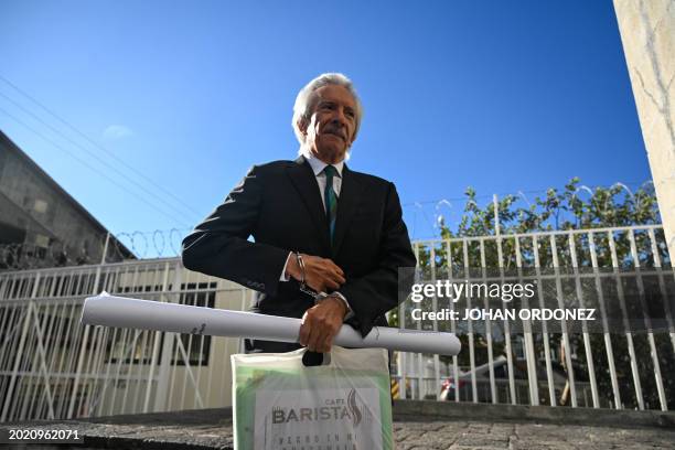 Guatemalan journalist José Rubén Zamora, founder of the defunct newspaper El Periódico, arrives handcuffed for a hearing at the Palace of Justice in...