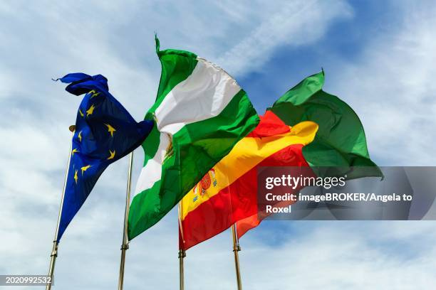 four flags next to each other, fluttering in the wind, strong wind, european union, andalusia, spain, granada, alhambra, spain, europe - spanish association stock pictures, royalty-free photos & images