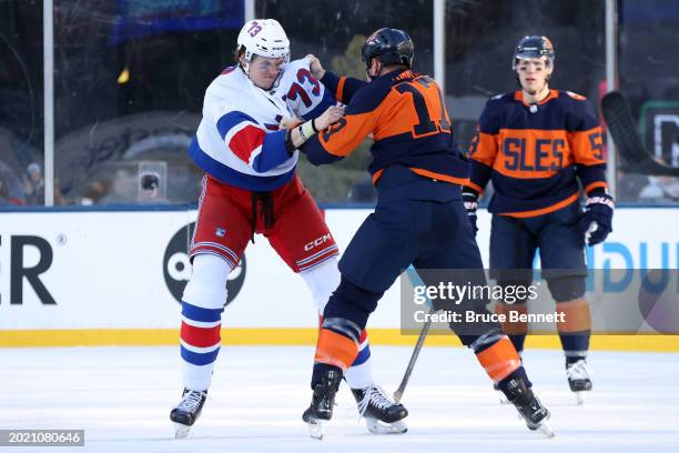 Matt Rempe of the New York Rangers, playing in his first career NHL game fights with Matt Martin of the New York Islanders during the first period...