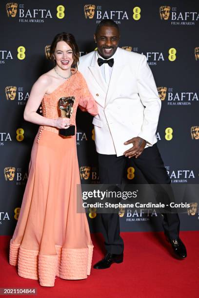 Emma Stone and Idris Elba pose with the Leading Actress Award in the winners room at the 2024 EE BAFTA Film Awards at The Royal Festival Hall on...