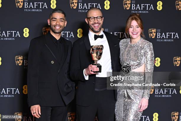 Kingsley Ben-Adir, Cord Jefferson and Bryce Dallas Howard pose with the Adapted Screenplay Award in the winners room at the 2024 EE BAFTA Film Awards...