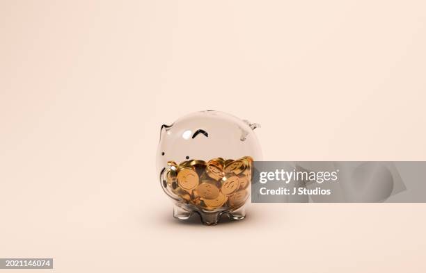 glass piggy bank with gold dollar coins - spardose stock-fotos und bilder