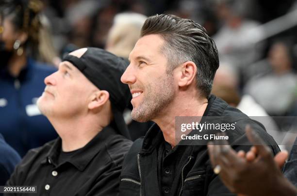 Washington Commanders head coach Dan Quinn and general manager Adam Peters are introduced to the crowd during the first half of the game between the...