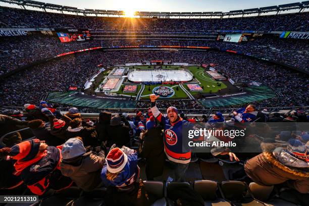 Fans celebrate a goal by Anders Lee of the New York Islanders during the second period against the New York Rangers during the 2024 Navy Federal...