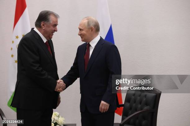 Russian President Vladimir Putin shakes hands with Tajik President Emomali Rakhmon during their meeting, February 2024, in Kazan, Russia. Putin is...