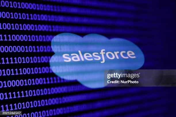 Binary code and Salesforce logo are seen in this multpiple exposure illustration photo taken in Krakow, Poland on February 21, 2024.