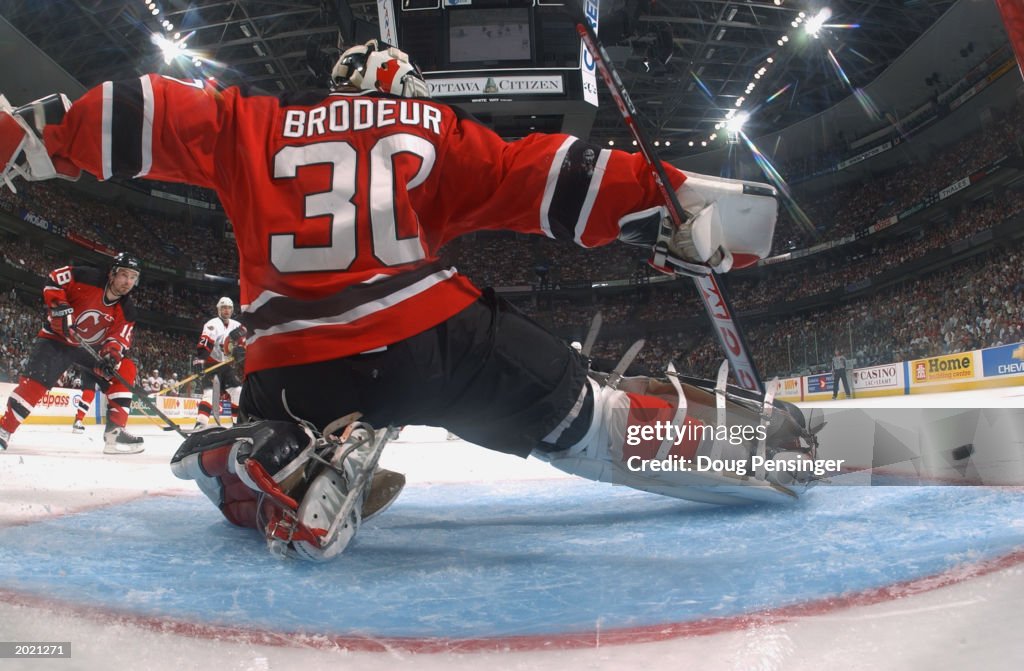 Martin Brodeur goes down to make a save