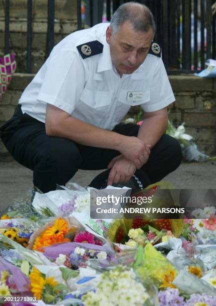 Acting Deputy Chief Constable Keith Hoddy pays his respects at St Andrew's Church, Soham, 21 August 2002 to 10-year-olds Holly Wells and Jessica...