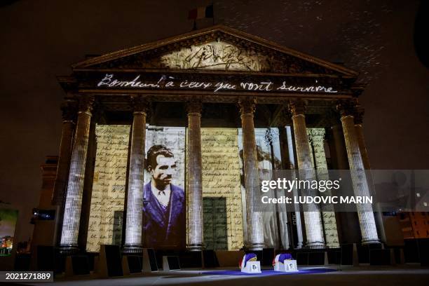 Photo shows the coffins layed outside The Pantheon as images are projected during a state ceremony for the induction into the mausoleum of Missak...