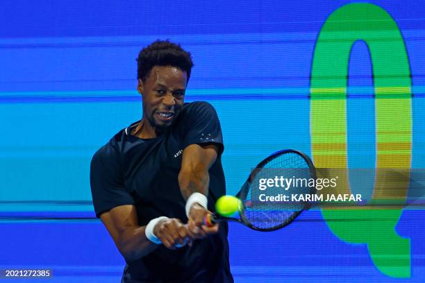 France's Gael Monfils hits a return against China's Zhang Zhizhen during their men's singles match at the ATP Qatar Open tennis tournament in Doha on...