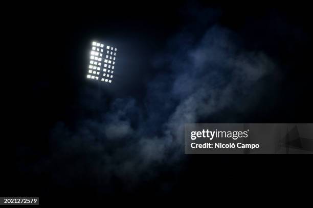 Smoke caused by flares lit by fans is illuminated by a spotlight during the Serie A football match between AC Monza and AC Milan. AC Monza won 4-2...