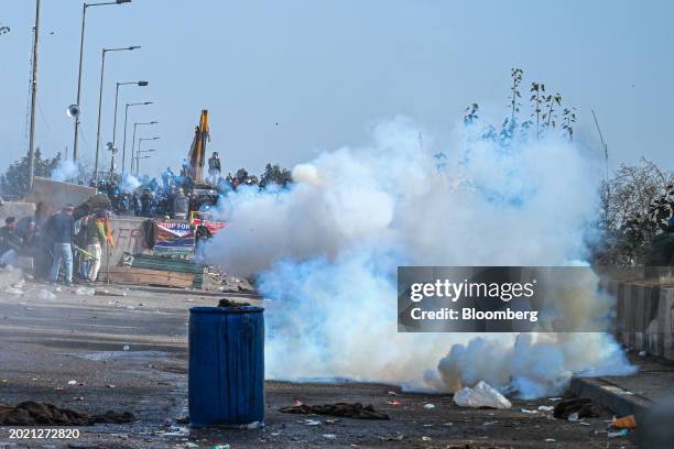 Police fire tear gas to prevent demonstrators from marching towards New Delhi during a protest by farmers near the Haryana-Punjab state border in...