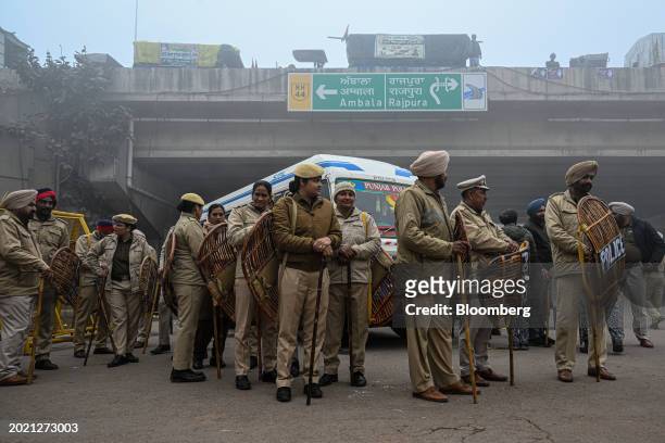 Police personnel stand guard during a protest by farmers near the Haryana-Punjab state border in Rajpura, Punjab, India, on Wednesday, Feb. 21, 2024....