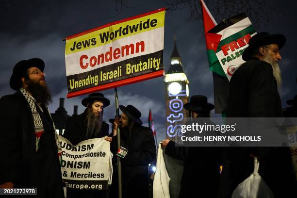 Members of the Ultra-Orthodox Jewish community hold placards as they protest in Parliament Square in London on February 21 during an Opposition Day...