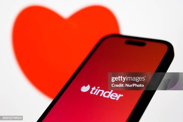 An image of heart displayed on a laptop screen and Tinder logo displayed on a phone screen are seen in this illustration photo taken in Krakow,...