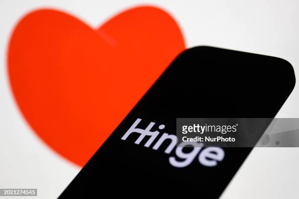 An image of heart displayed on a laptop screen and Hinge logo displayed on a phone screen are seen in this illustration photo taken in Krakow, Poland...