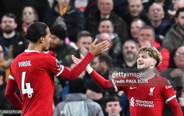 Liverpool's English midfielder Harvey Elliott celebrates with Liverpool's Dutch defender Virgil van Dijk after scoring his team fourth goal during...